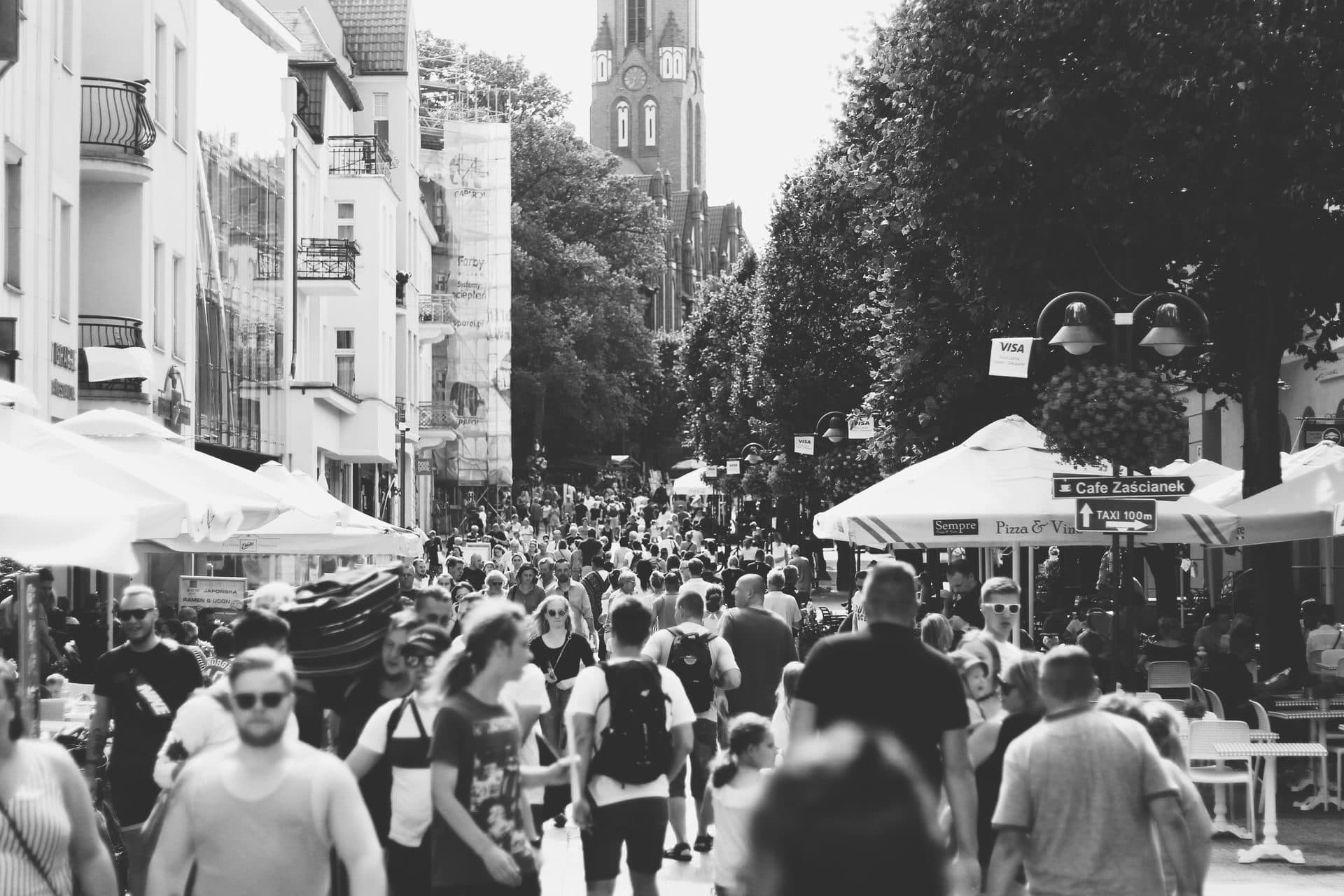 A busy community street scene in black and white