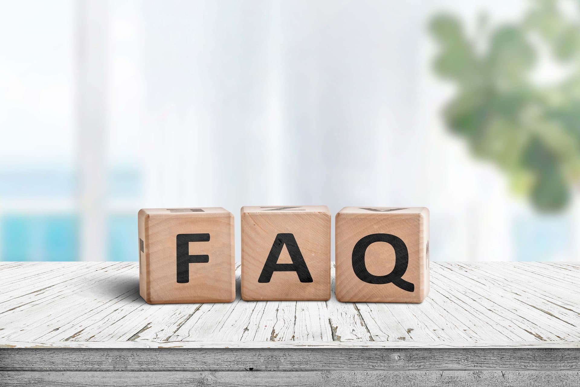 Wooden blocks spelling FAQ on a table